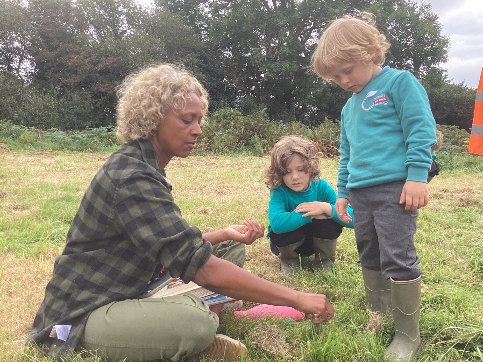 Children being taught outside on grass